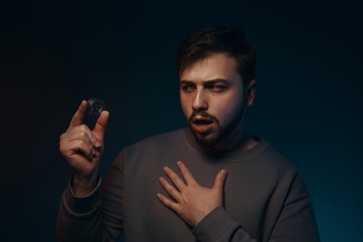 A young man with a bitcoin in his hands. Cryptocurrency. photo