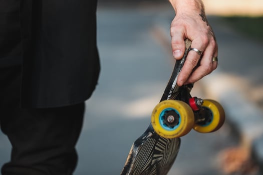 Longboard close-up. Skate in the hands of a guy. photo