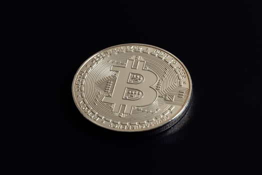 Bitcoin on black background. Cryptocurrency trading. Macro photo