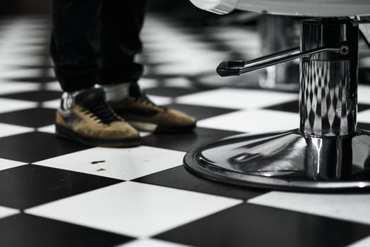 Barber shop interior with black and white tile floor and stylish footwear photo