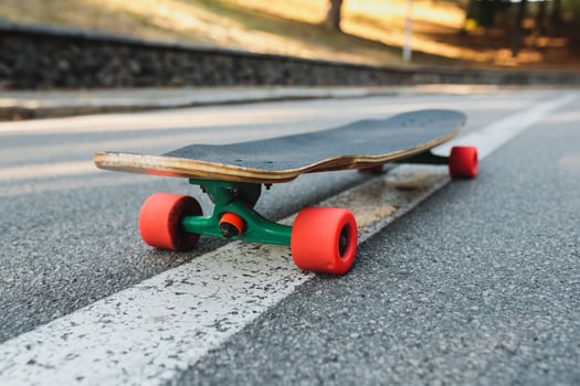Longboard with red wheels on the asphalt. photo