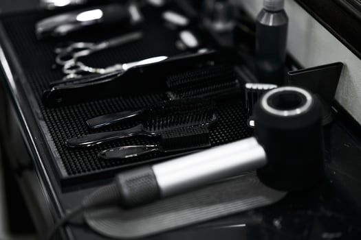 Tools arranged neatly on a salon counter ready for hairstyling services photo