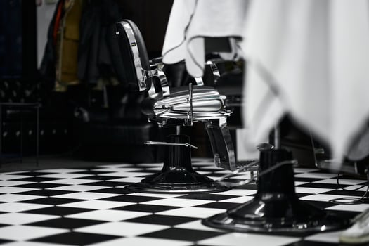 Vintage barber chairs and checkered floor in a classic barbershop setting photo