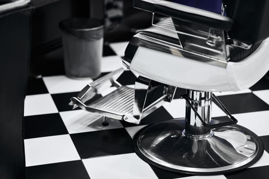 Modern barber chair in a stylish black and white salon interior photo