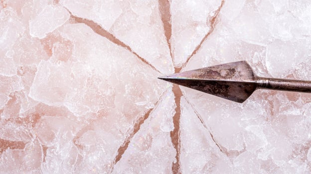 Cracked ice with metal arrow photo
