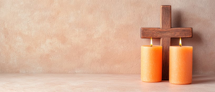 wooden cross and burning candles on plain background photo