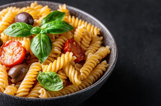 Delicious pasta dish with fresh basil and tomatoes photo