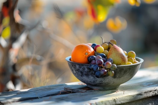 Colorful autumn fruit bowl on rustic wooden table photo