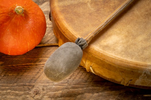 handmade, native American style, shaman frame drum covered by goat skin with a beater or a rustic wood with winter squash photo