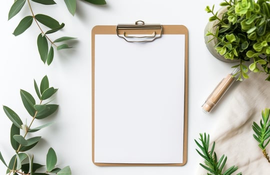 Blank clipboard with green leaves and plants photo