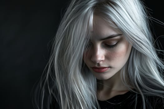 Dramatic portrait of a woman with long, flowing silver hair photo