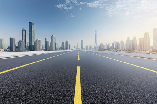 Asphalt Road Leading to Modern City Skyline Urban Landscape photo