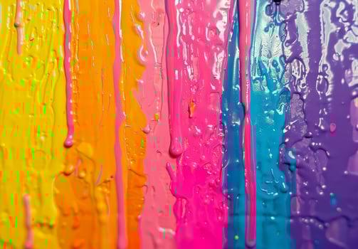 Vibrant Rainbow Paint Drips on a Wall photo