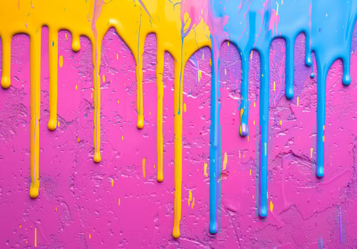 Colorful paint drips on a textured pink background photo