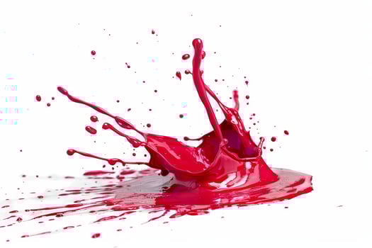 Vibrant red paint splash isolated on white background photo