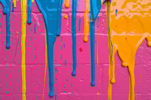 Colorful paint drips on a pink background photo
