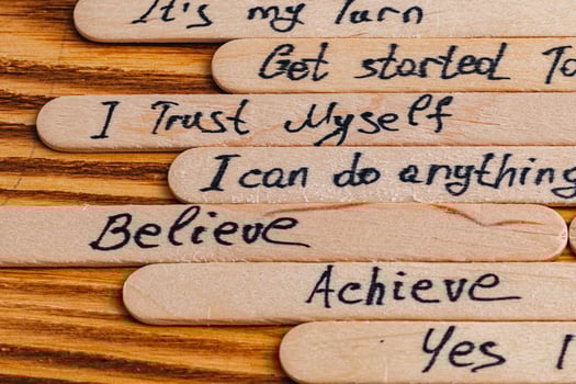 Positive thoughts for increasing selfesteem on wooden posts on wooden background photo