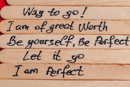 Positive thoughts for increasing selfesteem on wooden posts on wooden background photo