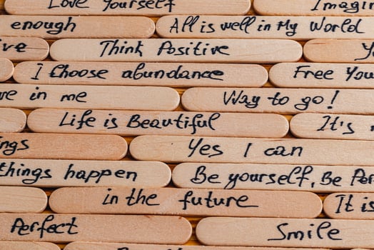 Positive thoughts for increasing selfesteem on wooden posts on wooden background photo