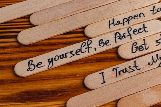 Positive thoughts for increasing selfesteem on wooden posts on wooden background photo