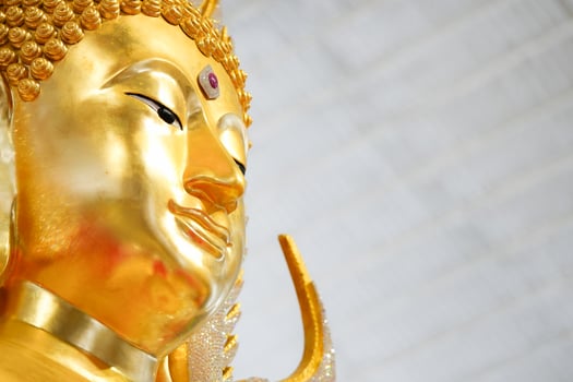 A stunning golden Buddha sculpture, exemplifying the deep reverence and devotion of Thai individuals in their spiritual worship. photo