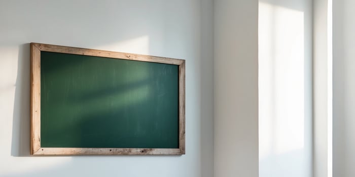 Empty Green Chalkboard with Wooden Frame on a White Wall. photo