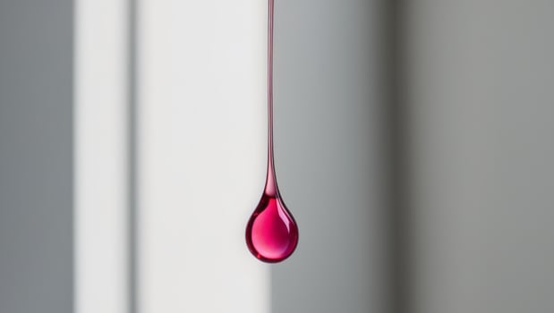 Elegance in simplicity A single drop of pink liquid. photo