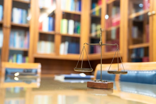Old Brass Law Scale vintage style is laid on wood glass table in Lawyer office meeting room. photo