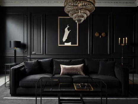 Dark Living Room Decor With Black Sofa And Artwork photo