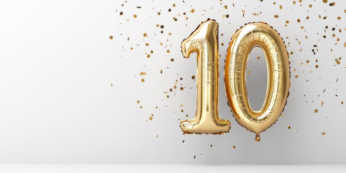 Golden metallic balloon number 10 with confetti for celebrations and anniversaries photo