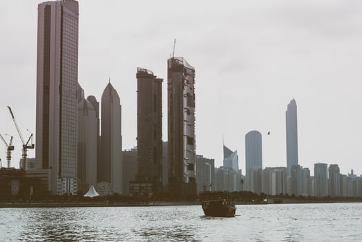 Abu Dhabi buildings skyline with old fishing boat photo