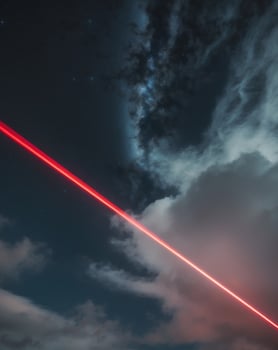 Starry night sky with radiant glowing red light beams. photo