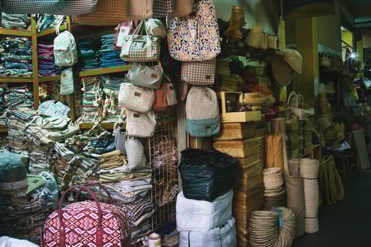 Colorful Craft Store Displaying Woven Baskets, Bags, and Textiles photo