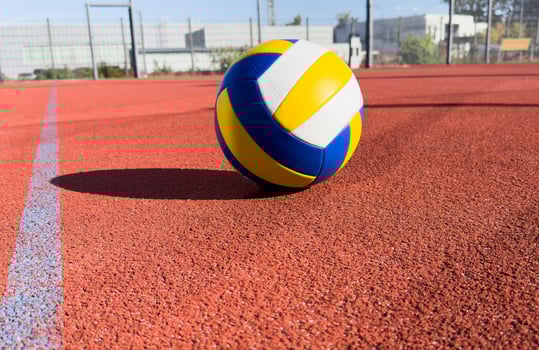 volleyball. blue with yellow color ball on the playground. volleyball cover, red. ball game photo