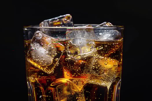 Close up of a refreshing glass of soda with ice cubes photo