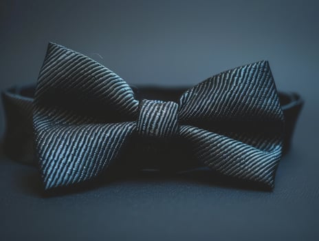 Elegant black bow tie on a dark background photo