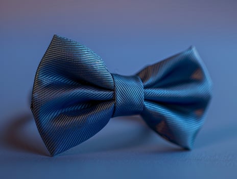 Elegant blue bow tie on a subtle gradient background photo