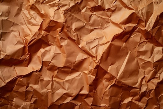 Textured crumpled brown paper background photo