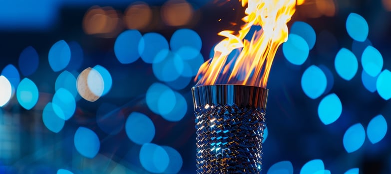 Flaming torch against a backdrop of blue lights photo