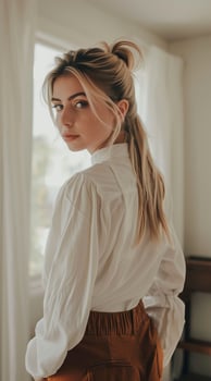 Elegant woman in stylish outfit by the window photo