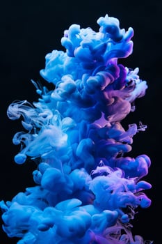 Vibrant blue and purple ink clouds in water photo