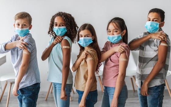 Kids Vaccination Against Covid-19. Diverse Group Of Vaccinated Children Showing Arms With Medical Plaster Bandage After Antiviral Vaccine Injection Standing Over Gray Wall Background photo