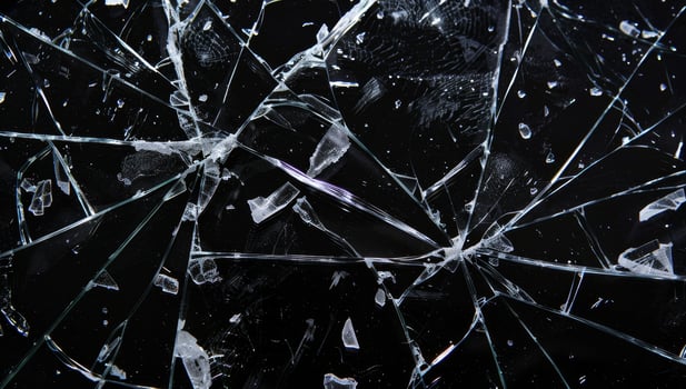 Close up of shattered glass with intricate crack patterns photo