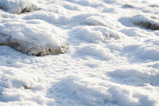 Close up of Snow Covered Rocks in Bright Sunlight photo
