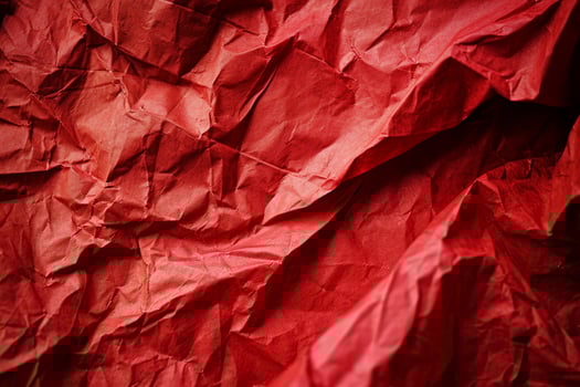 Close up of crumpled red paper texture photo