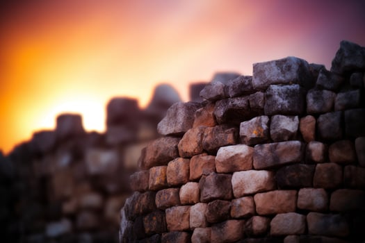 Stone wall against a vibrant sunset sky photo