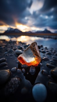 Sunset Glow Through a Translucent Ice on a Pebble Beach photo