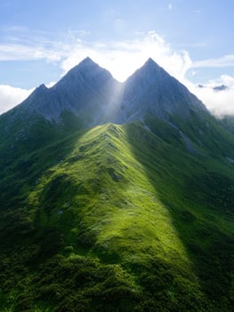 Majestic twin mountain peaks in lush green landscape photo