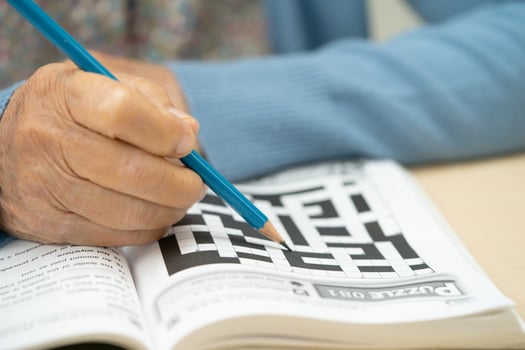 Asian elderly woman playing puzzle game. photo