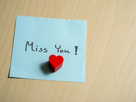 Heartfelt message home office note cozy environment close-up longing sentiment photo